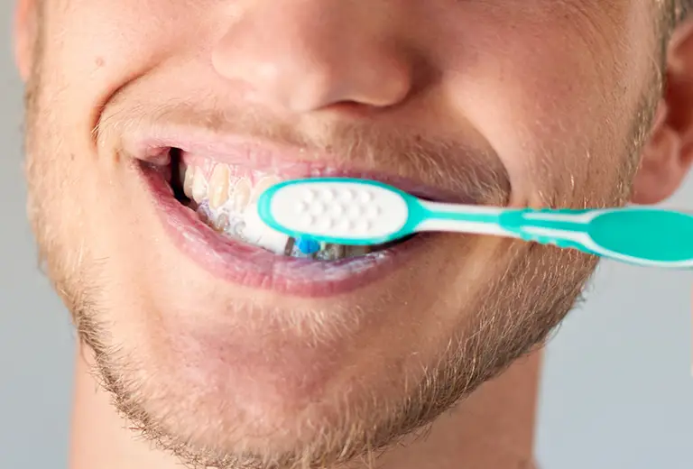 Closeup of man brushing teath